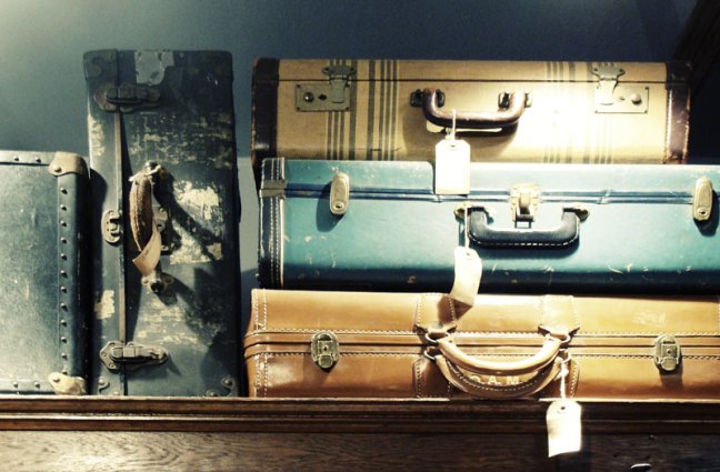 This photo shows a stack of vintage suitcases