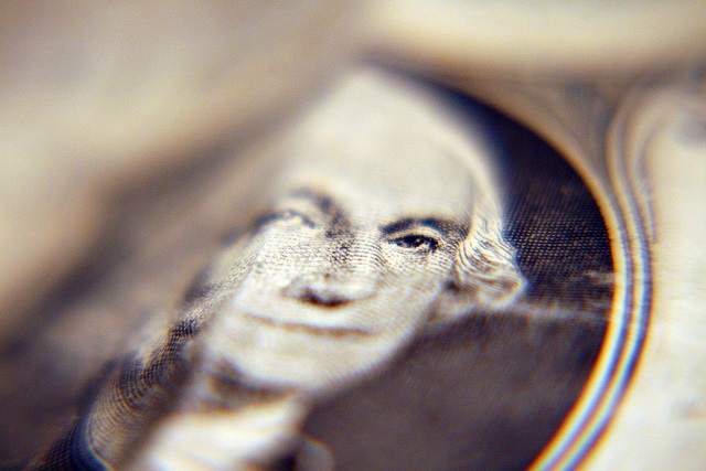 This photo shows a closeup of George Washington's image on the US $1 bill